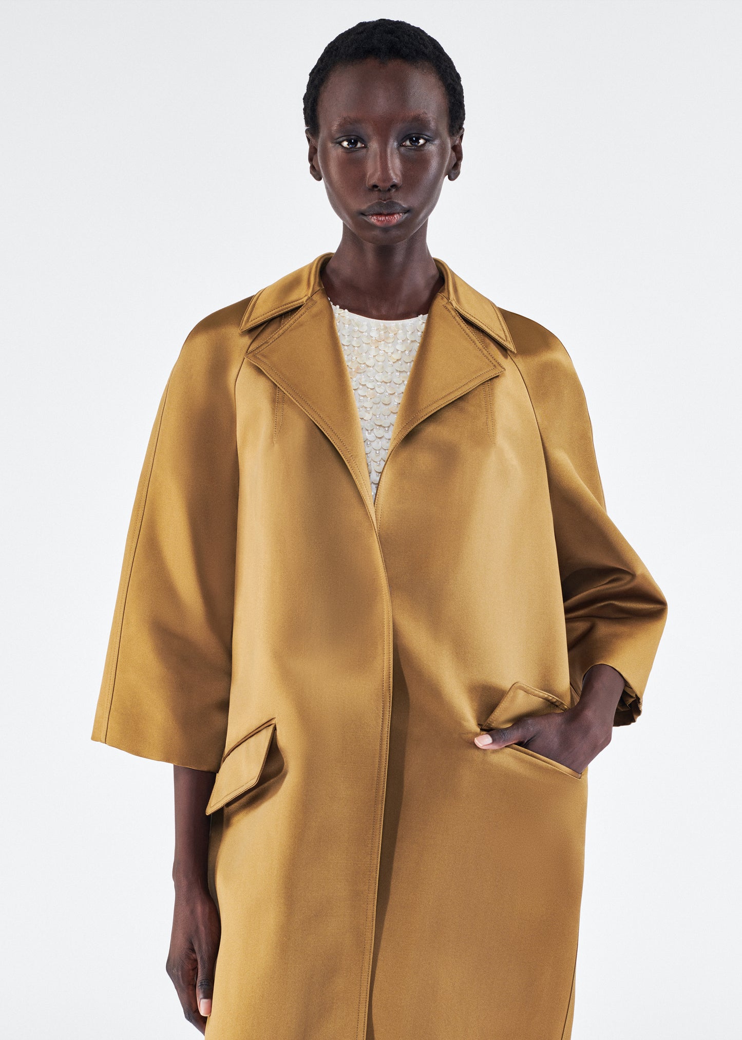 Model is wearing Opera Coat in Duchess Satin in Bronze