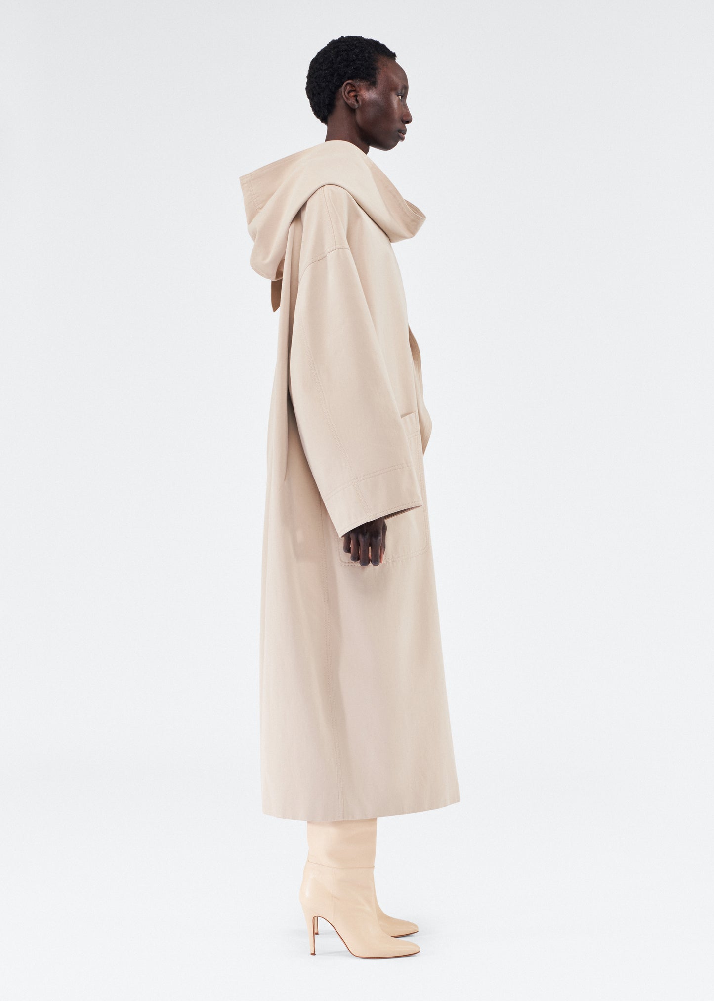 side view of model wearing gesse coat by adam lippes in cotton twill in khaki