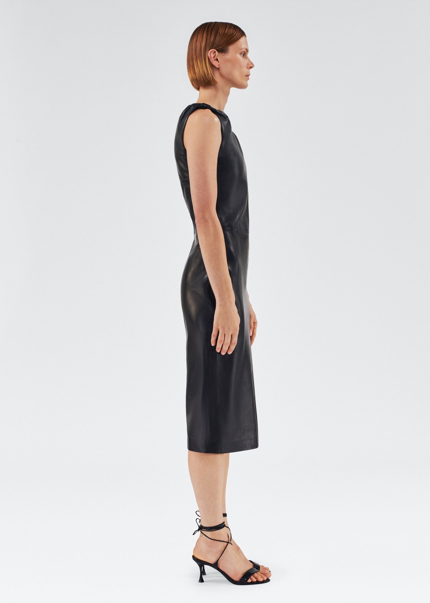 Side of model wearing the Hailee Dress in Leather in Black