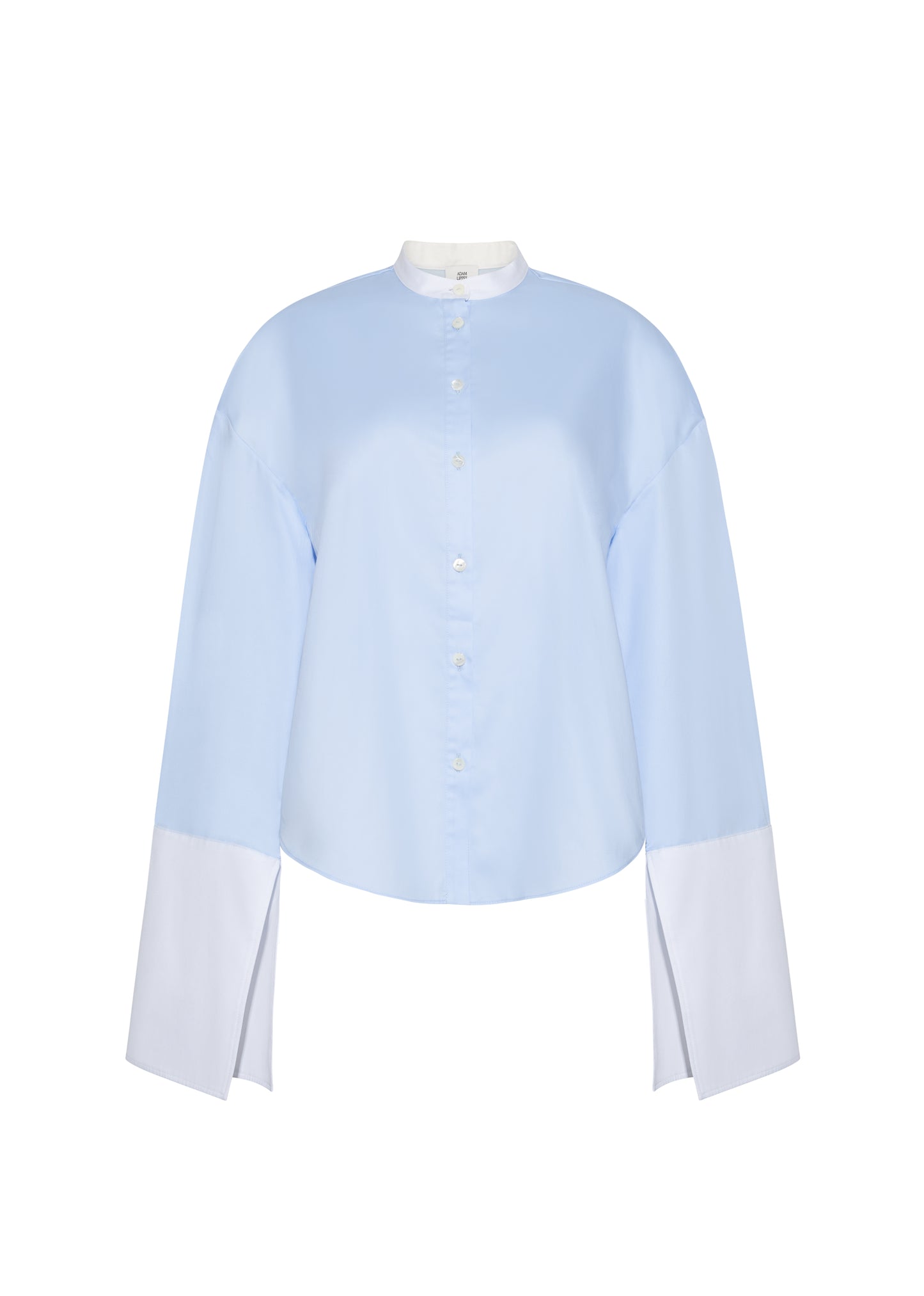 Ghost image front – bram top, P25139CS, Pale Blue – Adam Lippes, P25 collection: A new shape from the atelier, the Bram Top is crafted from soft organic cotton poplin in a refreshing pale blue hue. The relaxed fit is enhanced by contrasting white cuffs and collar, with a subtle slit near the cuffs for added detail. Made from the highest quality cotton and featuring diamond monogram mother of pearl buttons down the center front, the top offers elegance and comfort.