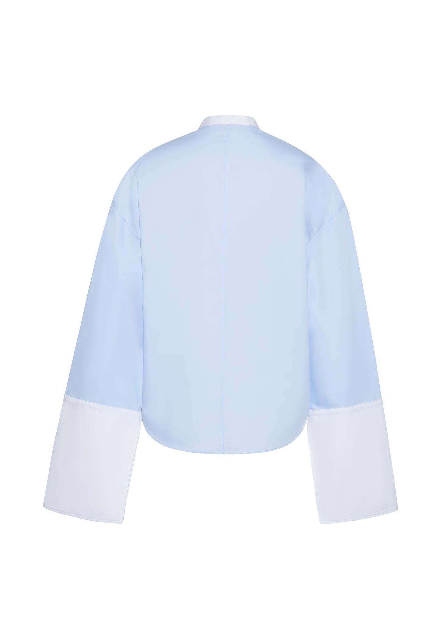 Ghost image back – bram top, P25139CS, Pale Blue – Adam Lippes, P25 collection: A new shape from the atelier, the Bram Top is crafted from soft organic cotton poplin in a refreshing pale blue hue. The relaxed fit is enhanced by contrasting white cuffs and collar, with a subtle slit near the cuffs for added detail. Made from the highest quality cotton and featuring diamond monogram mother of pearl buttons down the center front, the top offers elegance and comfort.