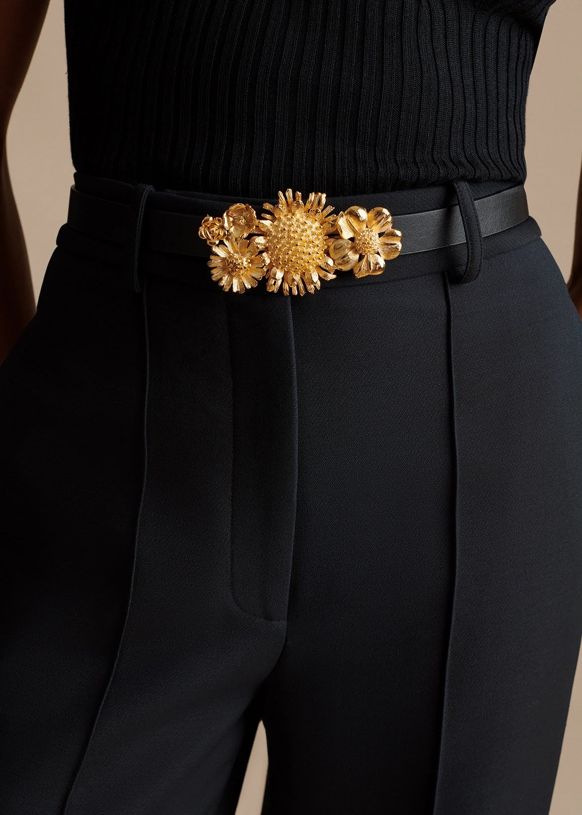 model wearing the gold floral garland belt by Adam Lippes