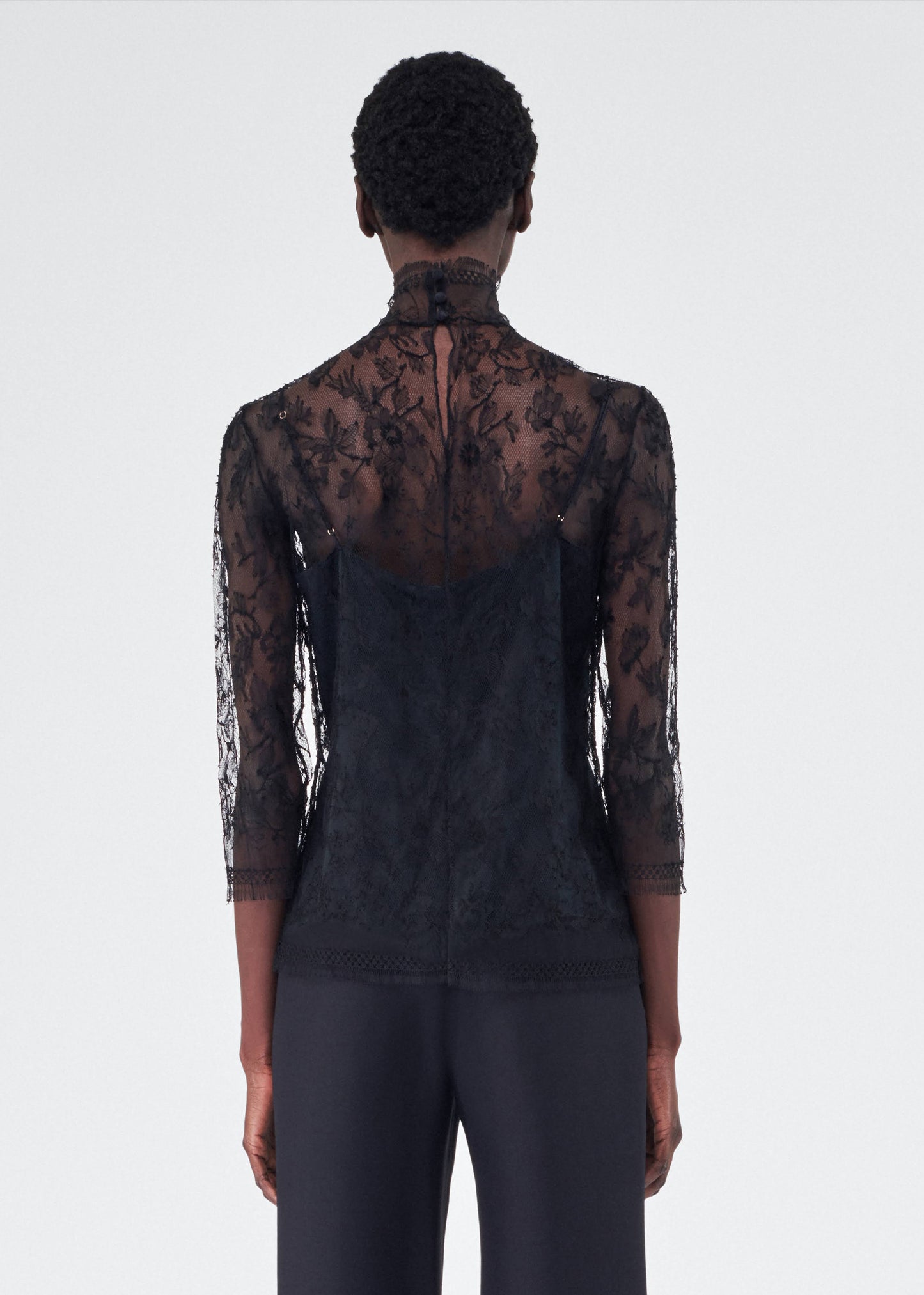 back view of model wearing the adam lippes chantilly lace turtleneck in black