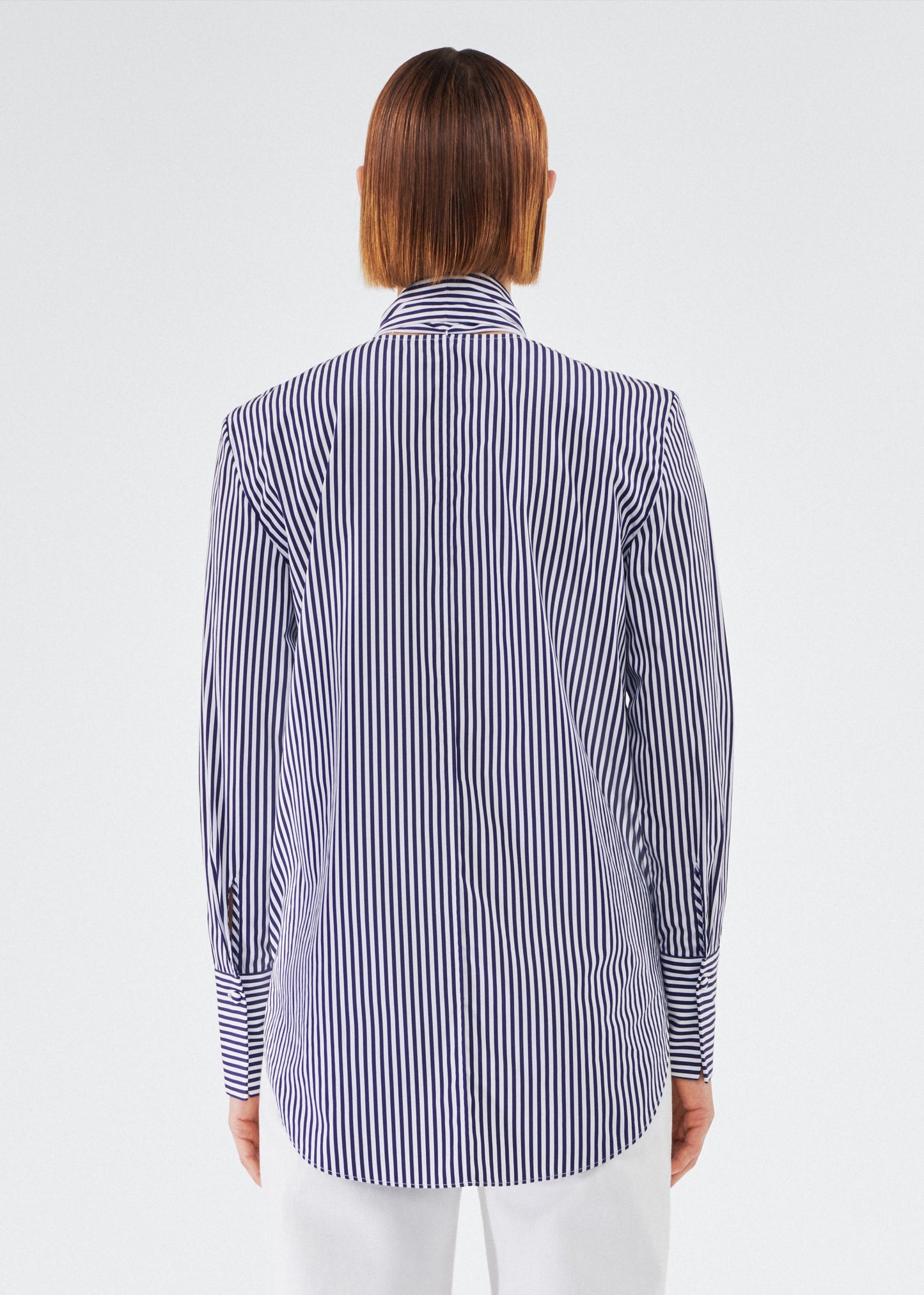 back view of model wearing lee blouse by adam lippes in striped poplin in navy and white