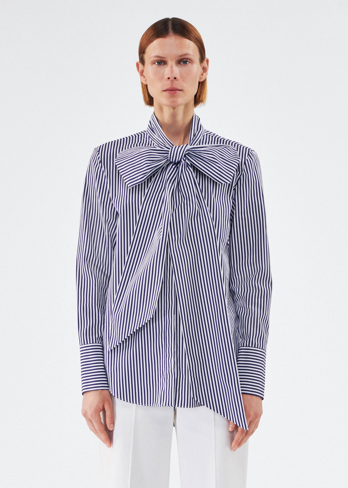 model wearing lee blouse by adam lippes in striped poplin in navy and white