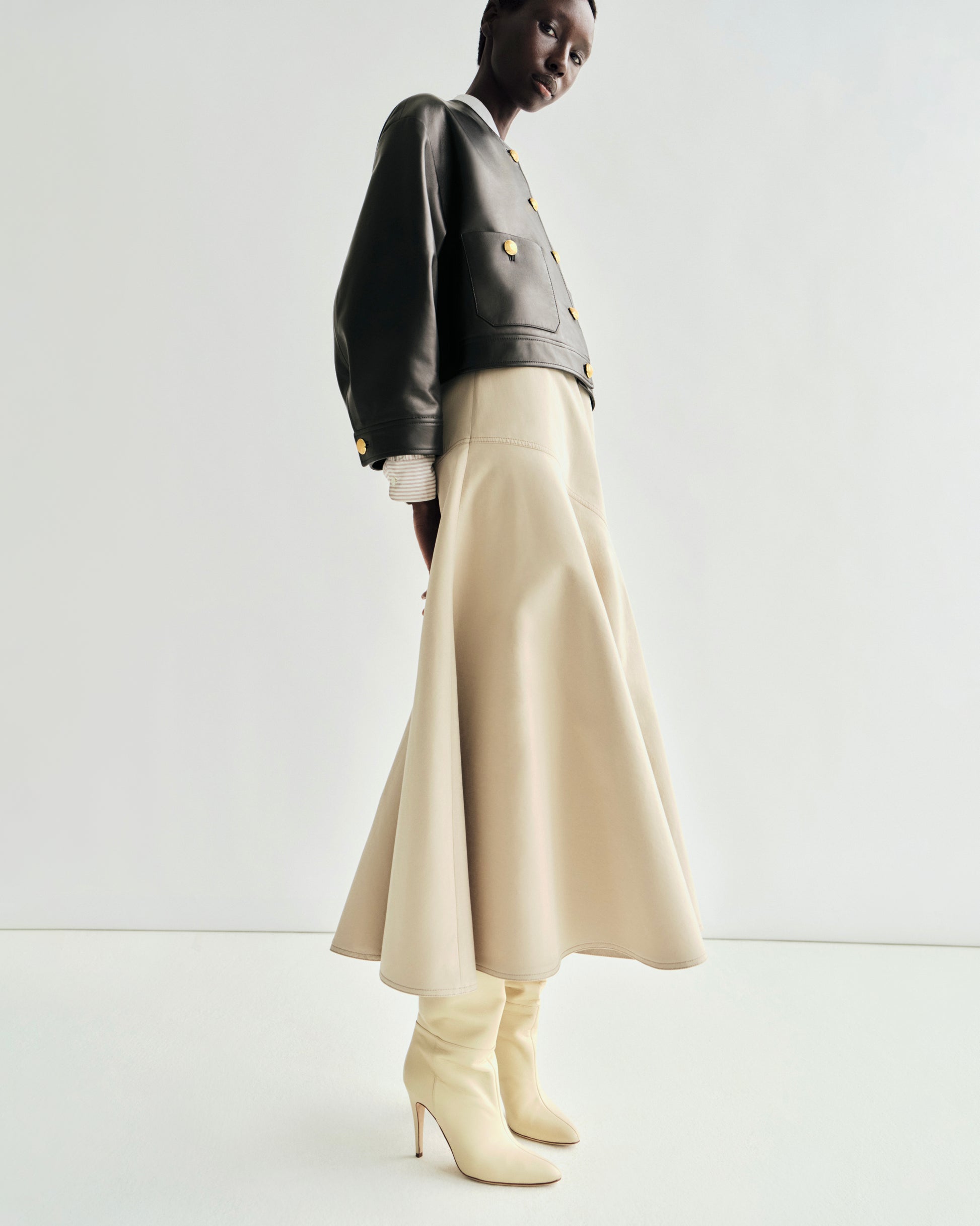 lookbook image of model wearing the tess skirt with the nessy leather jacket
