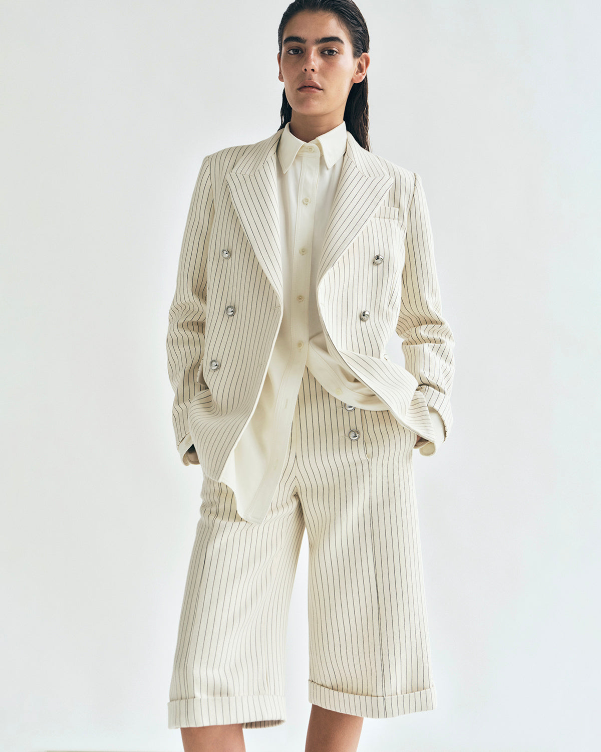 lookbook image of model wearing the devon short in pinstripe twill with the suffolk blazer in pinstripe twill by adam lippes