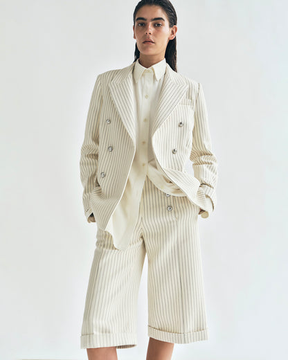 lookbook image of model wearing the devon short in pinstripe twill with the suffolk blazer in pinstripe twill by adam lippes