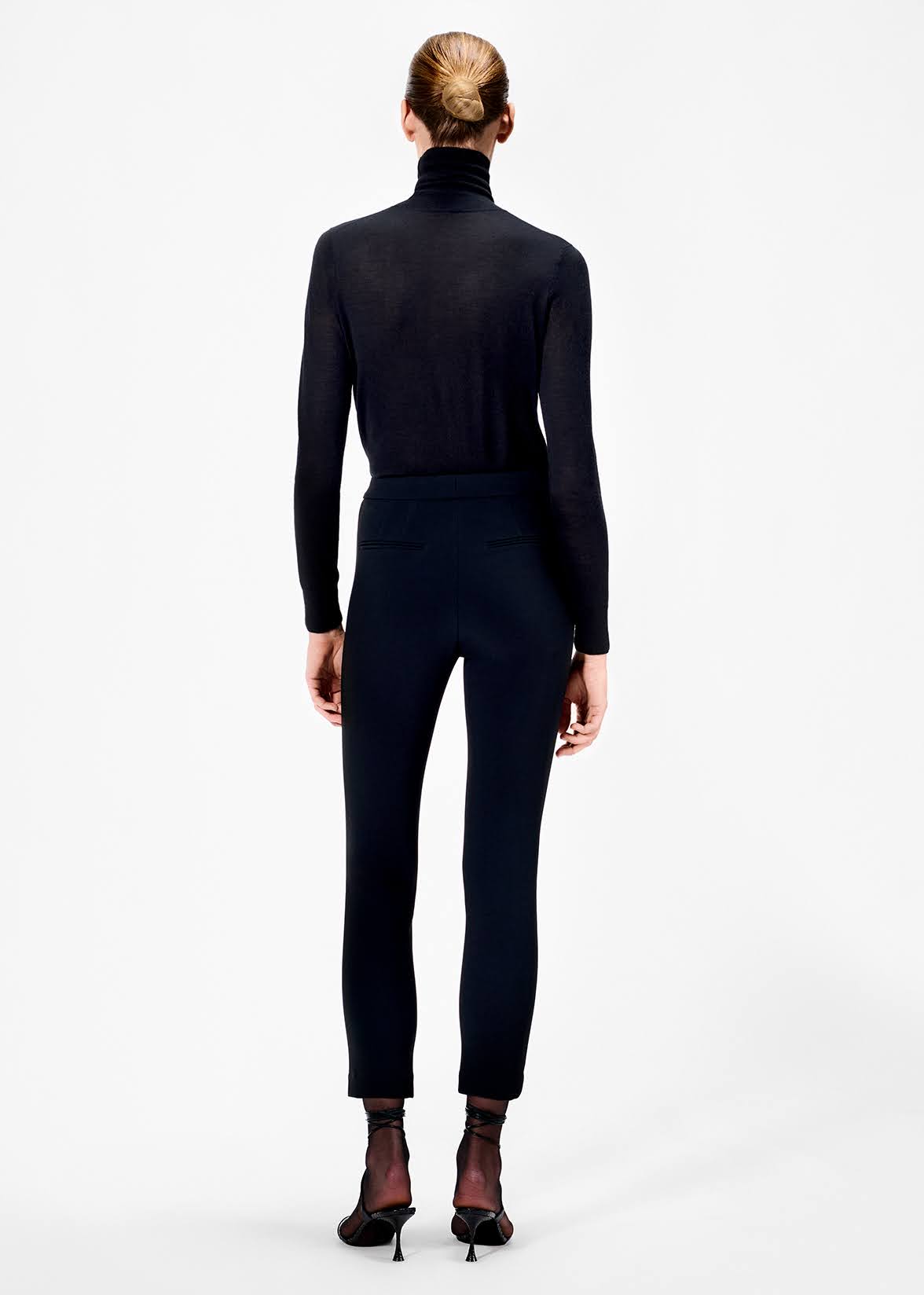 back of model wearing the cigarette pant in stretch cady in black by Adam Lippes