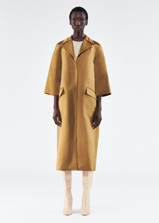 Model is wearing Opera Coat in Duchess Satin in Bronze 
