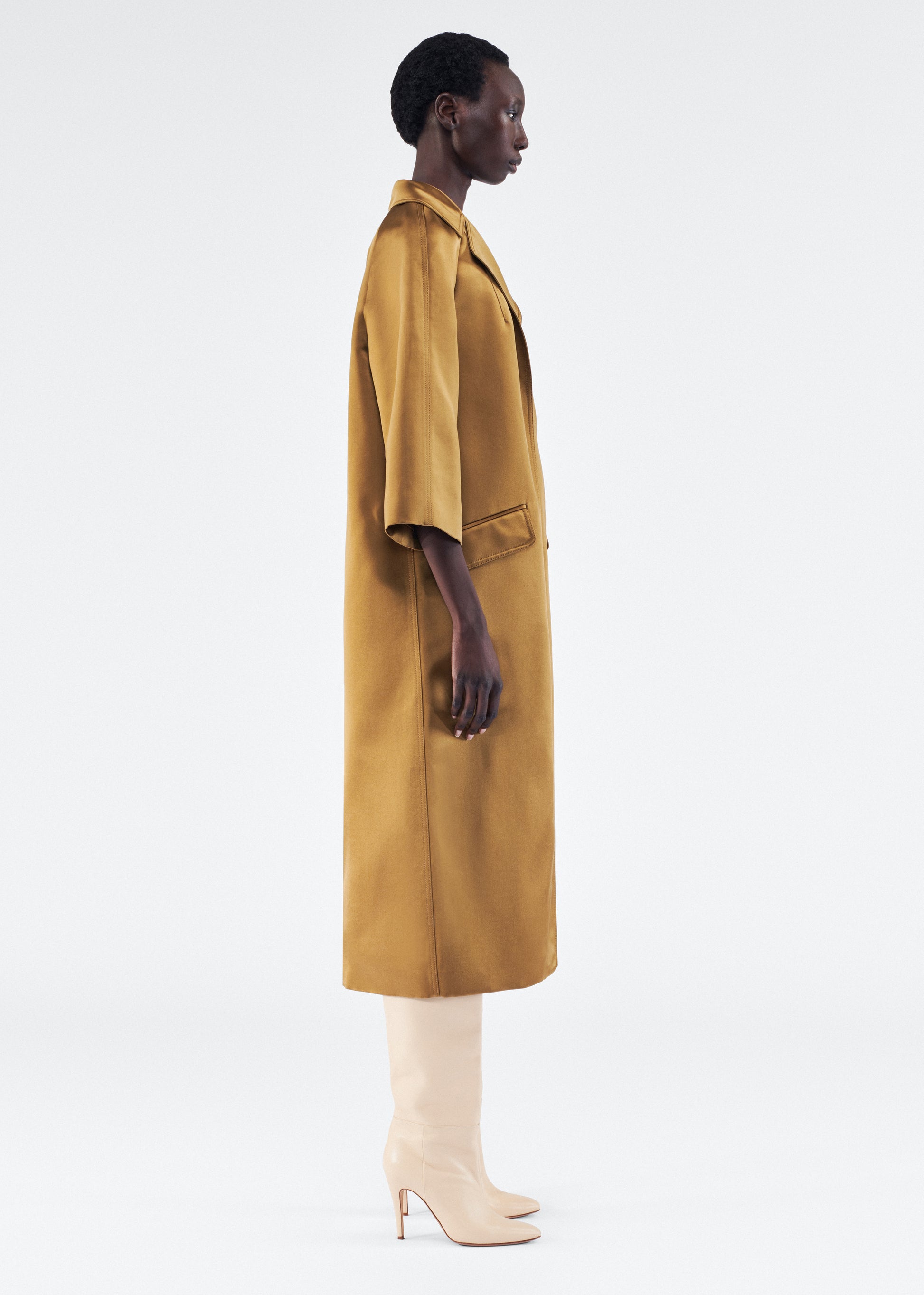 Model is wearing Opera Coat in Duchess Satin in Bronze 