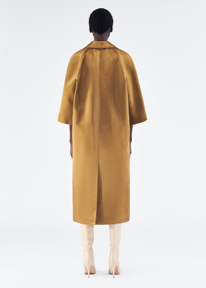 Model is wearing Opera Coat in Duchess Satin in Bronze 