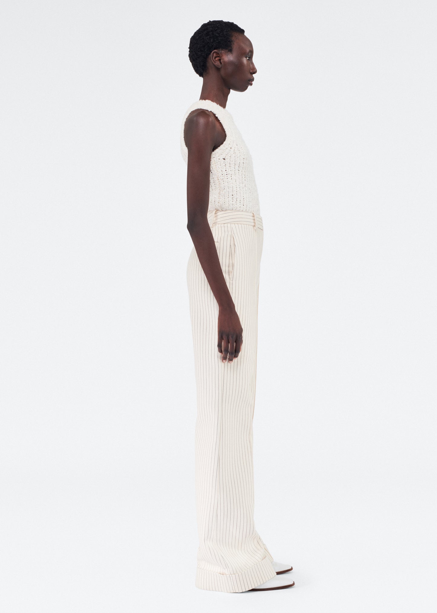 Side of model wearing the Deeda Pant in Pinstripe Twill in Canvas/Indigo