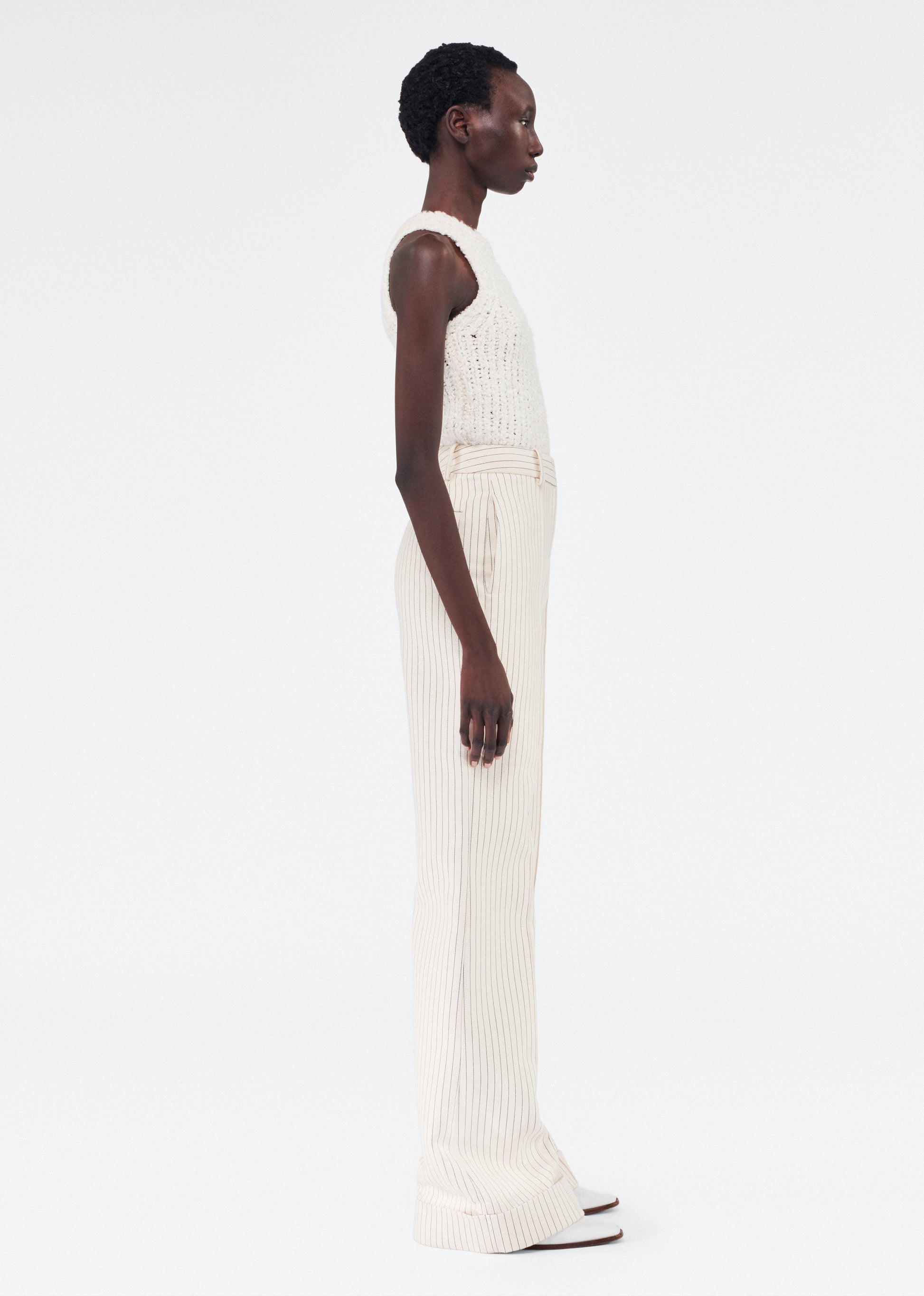 Side of model wearing the Deeda Pant in Pinstripe Twill in Canvas/Indigo