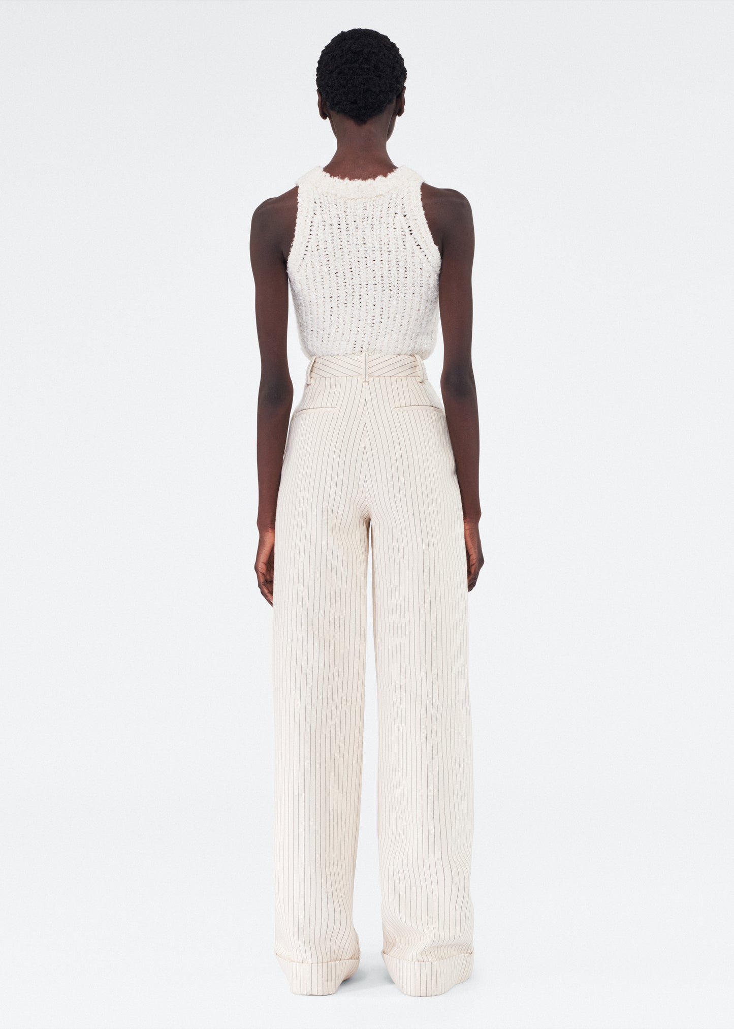 Back of model wearing the Deeda Pant in Pinstripe Twill in Canvas/Indigo