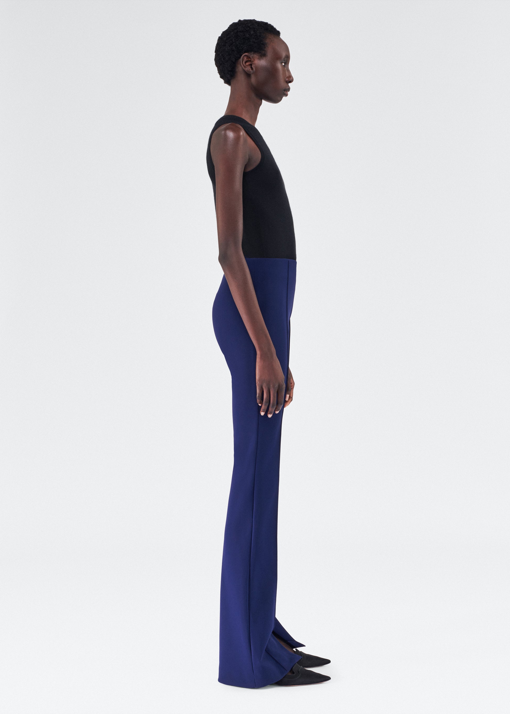 side view of model wearing the adam lippes eva flare pant in navy