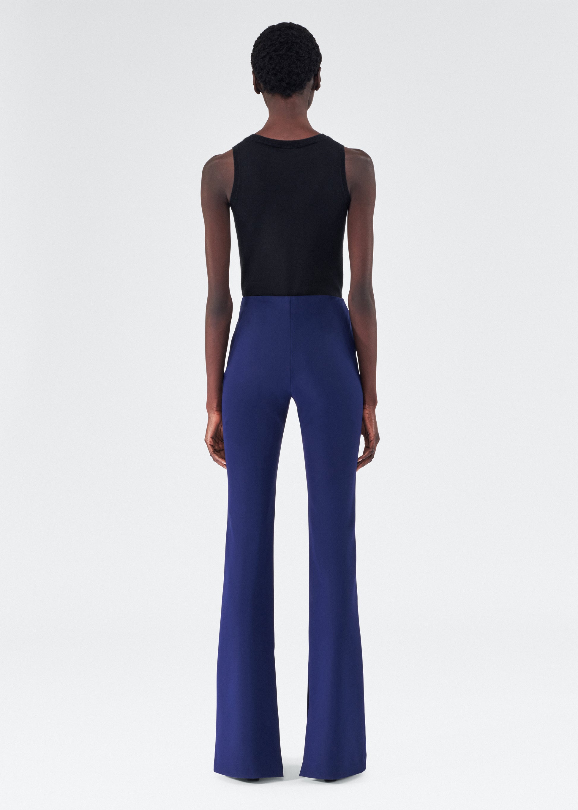 back view of model wearing the adam lippes eva flare pant in navy