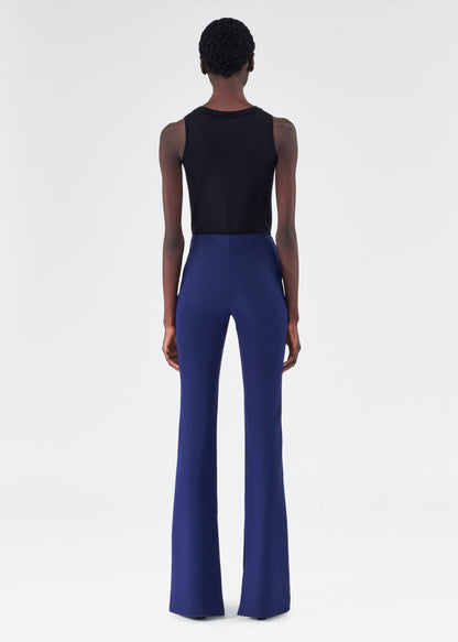 back view of model wearing the adam lippes eva flare pant in navy
