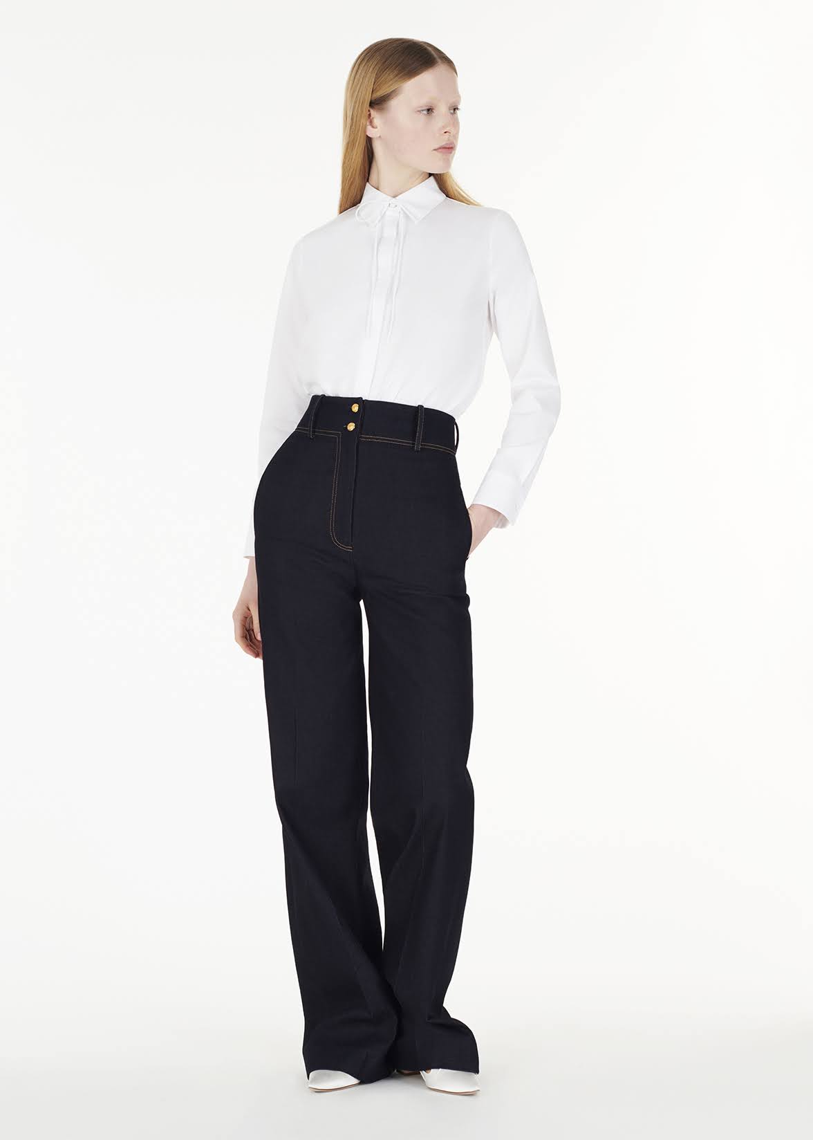 full body front of model wearing the shirt with thin bow with the hugo pant in indigo denim by Adam Lippes
