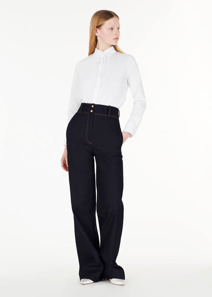 full body front of model wearing the shirt with thin bow with the hugo pant in indigo denim by Adam Lippes
