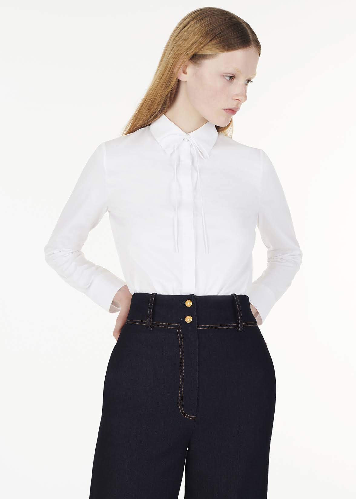 front facing photo of model wearing the shirt with thin bow with the hugo pant in indigo denim by Adam Lippes