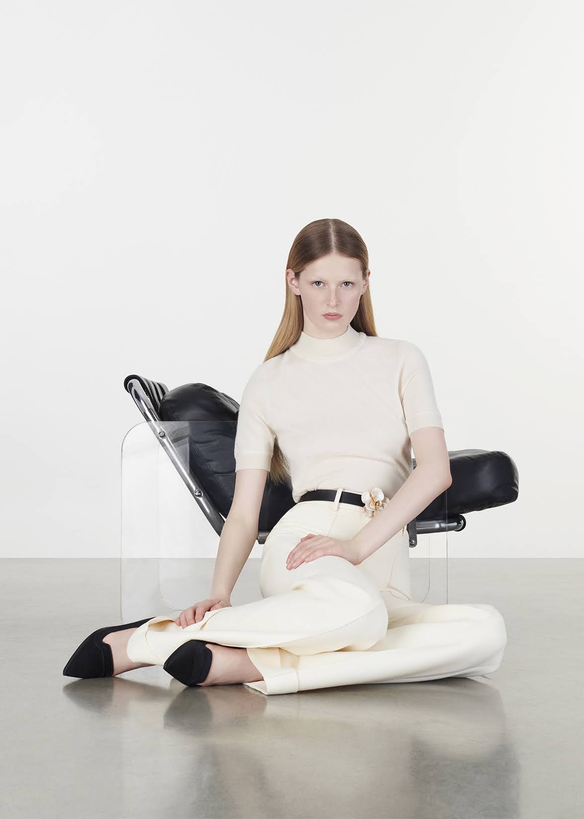 model wearing the mockneck top in ultra fine cashmere in ivory, sitting on the floor by Adam Lippes