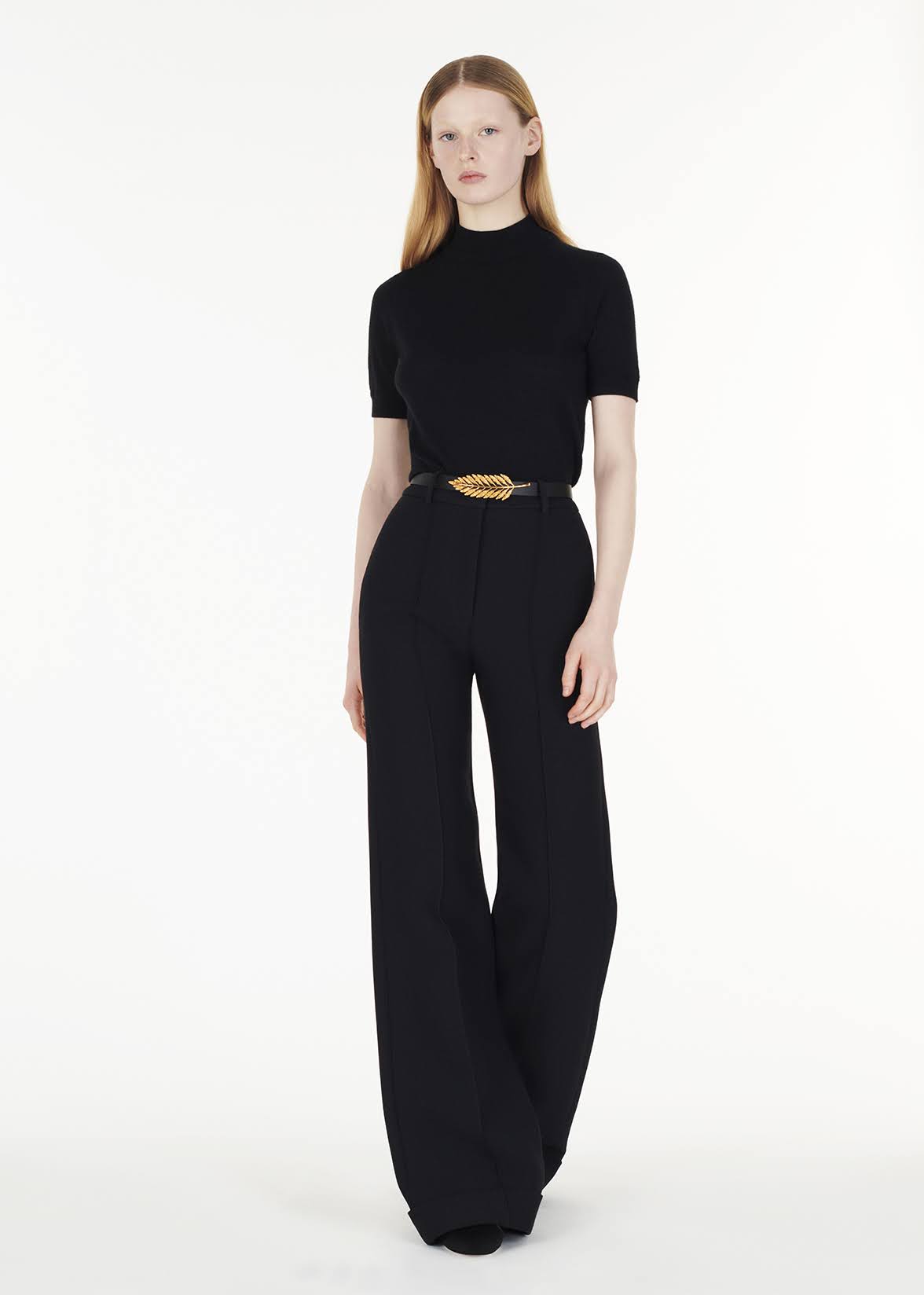 full body front facing image of model wearing the mockneck top in ultra fine cashmere in black by Adam Lippes