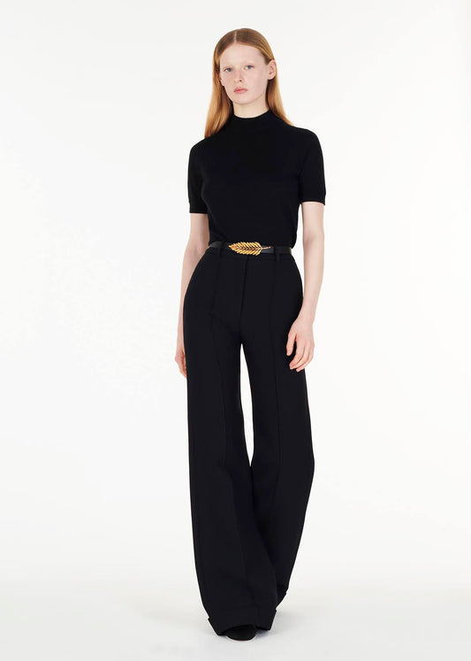 full body front facing image of model wearing the mockneck top in ultra fine cashmere in black by Adam Lippes