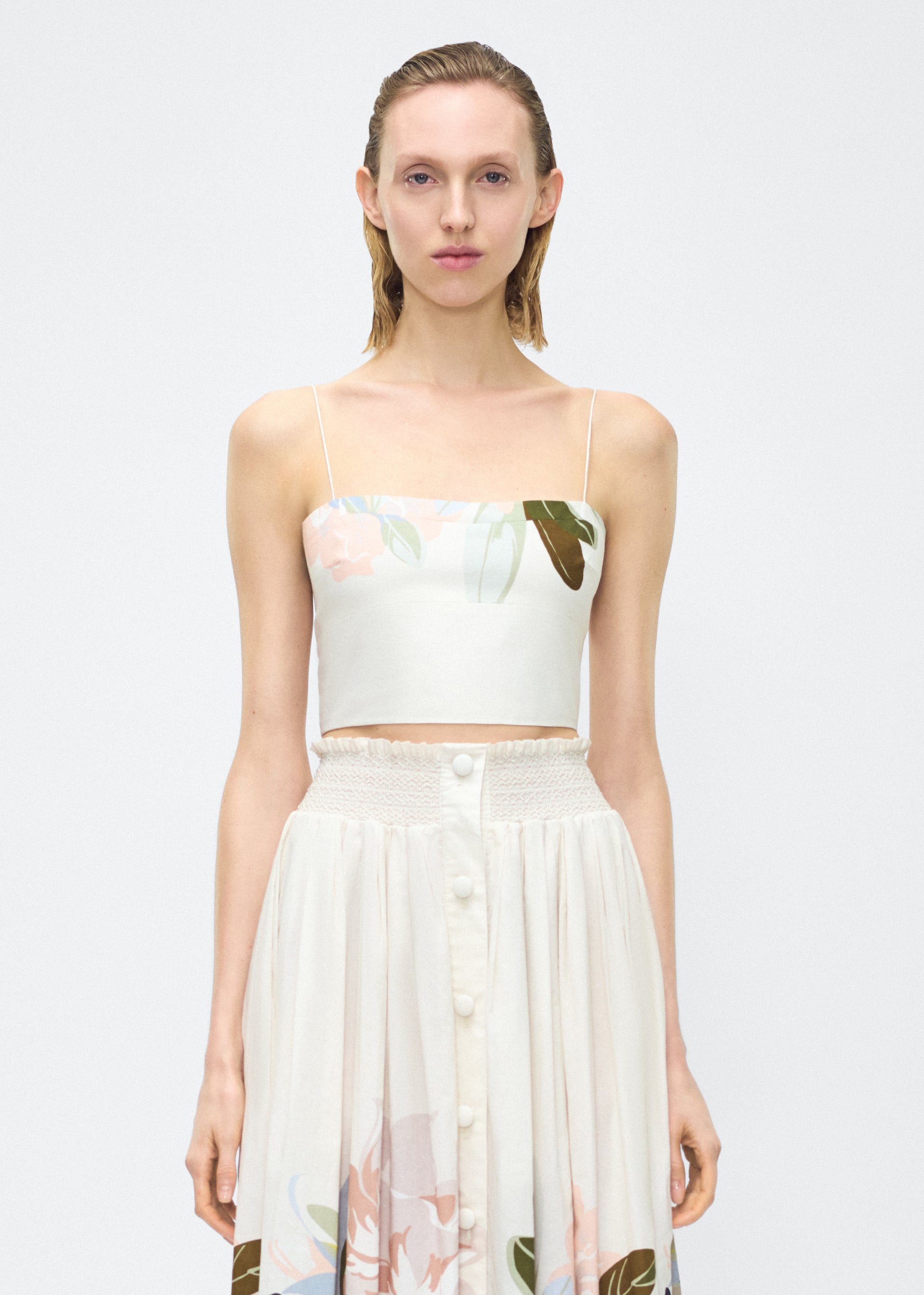 Image of model facing front – bex top, P25143PV, champagne/multi – Adam Lippes, P25 collection: Crafted from 100% cotton voile, the Bex Top showcases this season’s Sicily-inspired floral motif. The cropped silhouette offers a modern fit, while delicate straps and a clean neckline lend a minimalist touch. 