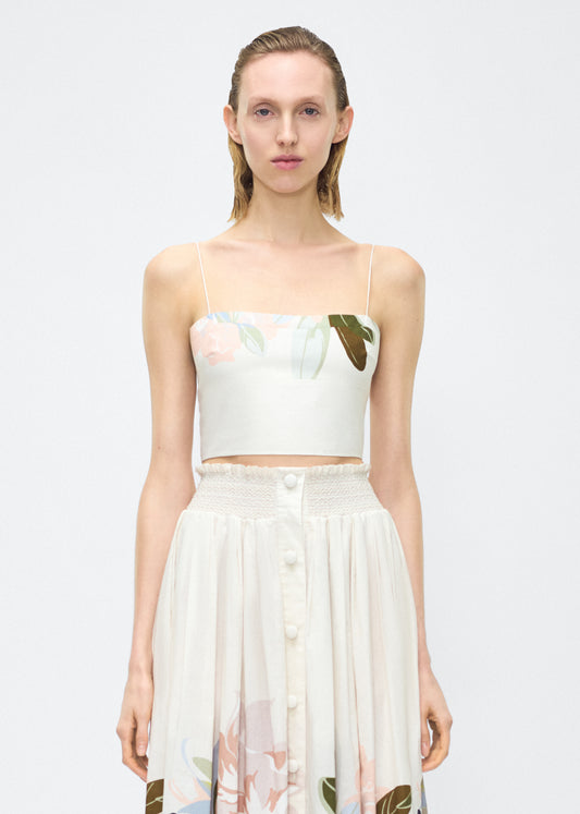 Image of model facing front – bex top, P25143PV, champagne/multi – Adam Lippes, P25 collection: Crafted from 100% cotton voile, the Bex Top showcases this season’s Sicily-inspired floral motif. The cropped silhouette offers a modern fit, while delicate straps and a clean neckline lend a minimalist touch. 