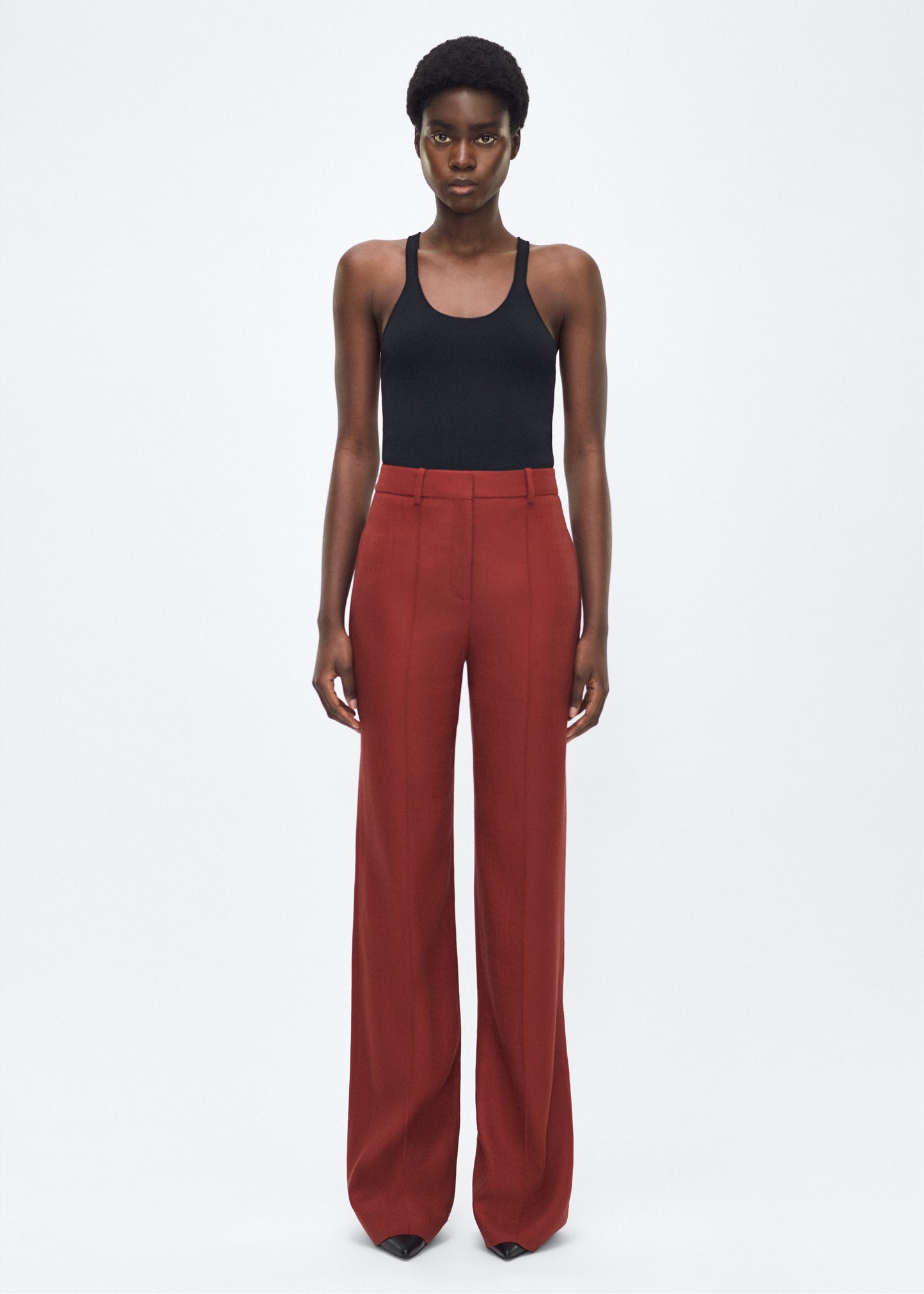 Image of model facing front – Wyatt Pant, P25507TR, Sienna – Adam Lippes, P25 collection: Precision tailoring meets modern ease in the Wyatt Pant, crafted in lightweight canvas and rendered in a rich sienna hue. The silhouette is clean and elongating, with a high-rise waist and fabric that moves effortlessly while holding its shape.