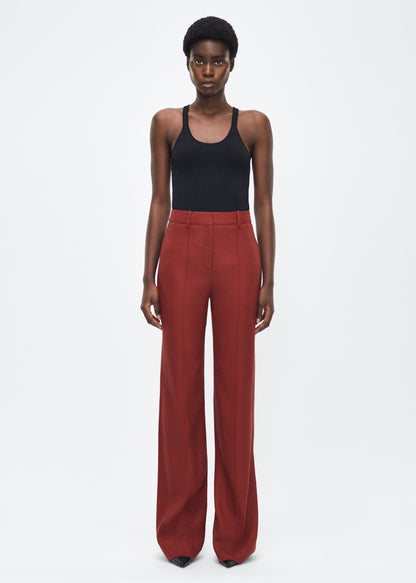 Image of model facing front – Wyatt Pant, P25507TR, Sienna – Adam Lippes, P25 collection: Precision tailoring meets modern ease in the Wyatt Pant, crafted in lightweight canvas and rendered in a rich sienna hue. The silhouette is clean and elongating, with a high-rise waist and fabric that moves effortlessly while holding its shape.
