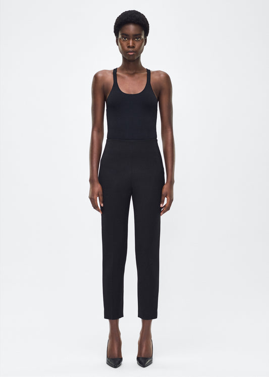 Image of model facing front– Kit Pant, P25512VT, Black – Adam Lippes, P25 collection: The Kit Pant introduces a sleek new silhouette, impeccably tailored in compact viscose. Designed to contour the legs, this ankle-grazing pant delivers effortless polish and modern ease.