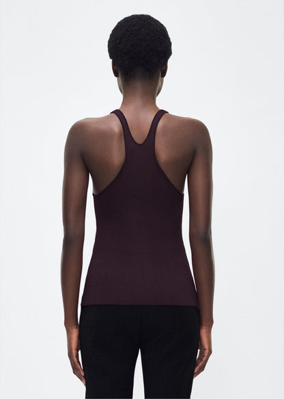 Image of model facing back – lumii tank , P25601VI, cacao – Adam Lippes, P25 collection: A new silhouette from the atelier, the Lumii Tank is crafted from luxurious knitted viscose. Clean lines and athletic-inspired straps make it a versatile piece for layering or wearing alone.
