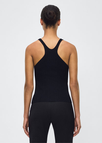 Image of model facing back with  lumii tank , P25624UB, black – Adam Lippes, P25 collection: A new silhouette from the atelier, the Lumii Tank is crafted from structured compact jacquard. Clean lines and athletic-inspired straps make it a versatile piece for layering or wearing alone.