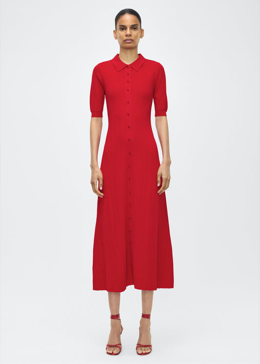 Model facing front – Fenwick Dress, P25626UB, Poppy – Adam Lippes, P25 collection: Crafted from a supple, ribbed knit, this dress skims th figure with ease, while an inset panel through the skirt introduces fluid movement. A button-down front and structured collar complete the look.