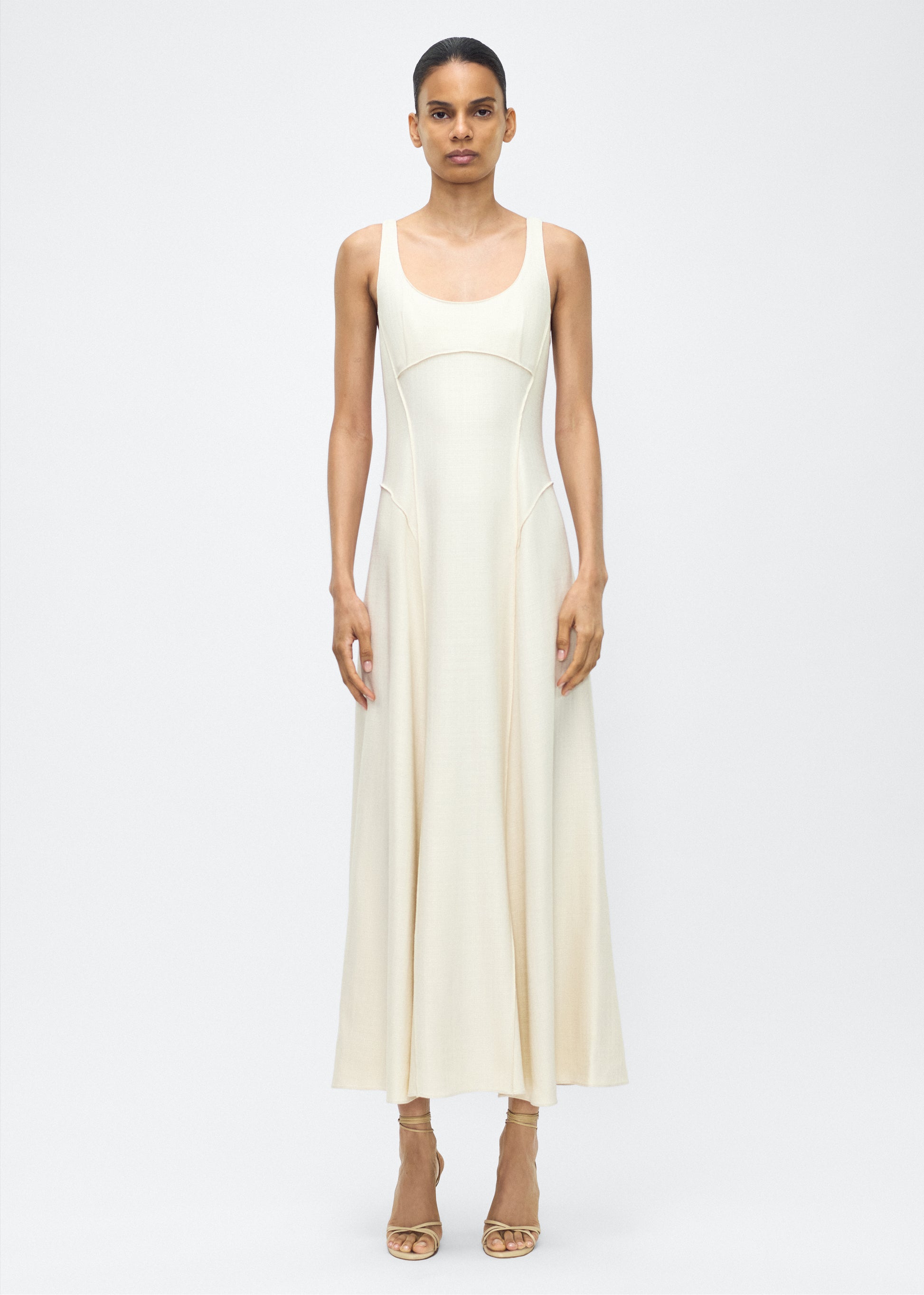 Model facing front, P25718TR, Shay Dress in Ivory, Crafted from versatile stretch canvas, the Shay dress features a structured silhouette with a softly contoured waistline and fluid, voluminous skirt. A scoop neckline and tailored side seams create an elongating effect.