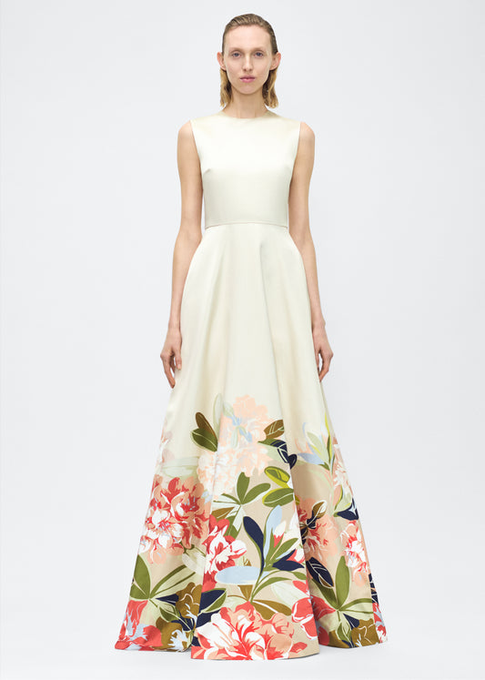 Image of model facing forward – Alienor Dress, P25731PU, Champagne/Multi – Adam Lippes, P25 collection: The Alienor Dress in printed duchess satin is defined by its elegant simplicity. Adorned with the Pre-Fall collection’s Sicily-inspired floral motif, it features a classic rounded neckline and flows gracefully for effortless wear.
