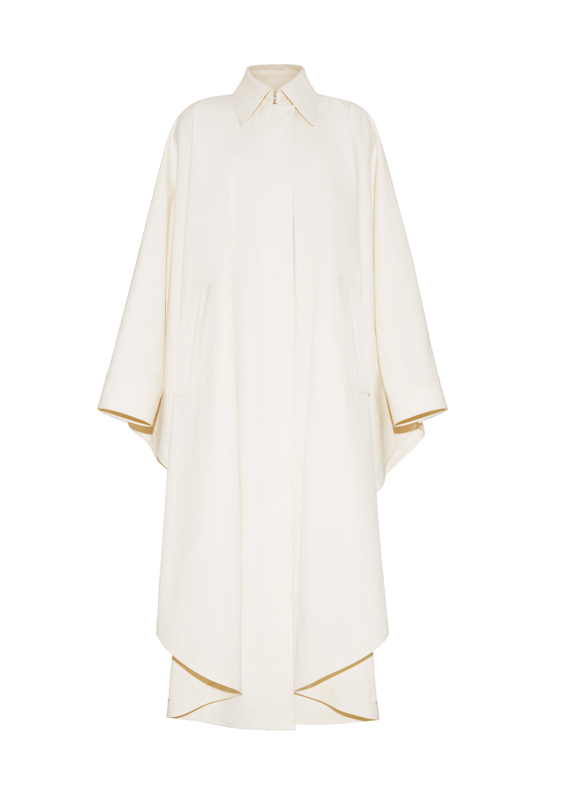 Ghost image front, The Langston Poncho, P25914CT, in color ivory, Adam Lippes P25 collection; The Langston Poncho in ivory cotton twill offers an elegant take on the classic poncho. With its modern, relaxed shape, sharp tailoring, and hidden corozo button closure down the center front, it effortlessly elevates any ensemble. The ivory hue and clean lines are complemented by thoughtful details.
