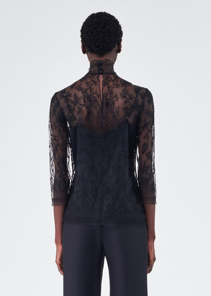 back view of model wearing the adam lippes chantilly lace turtleneck in black