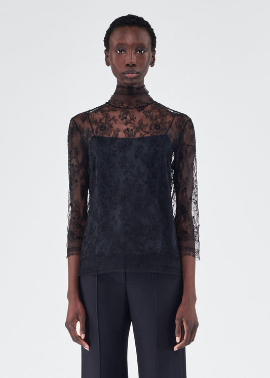 model wearing the adam lippes chantilly lace turtleneck in black