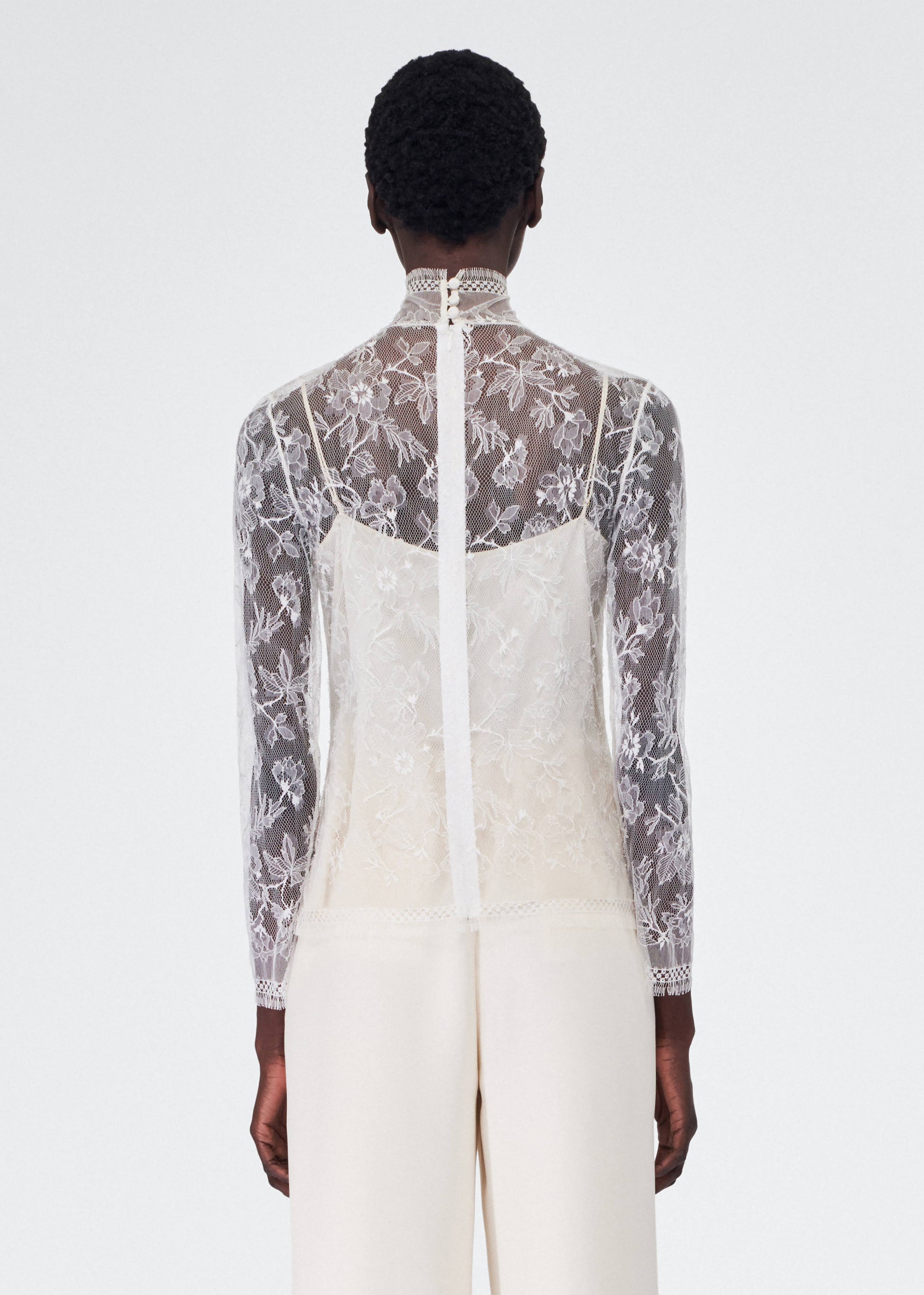 back view of model wearing the adam lippes chantilly lace turtleneck
