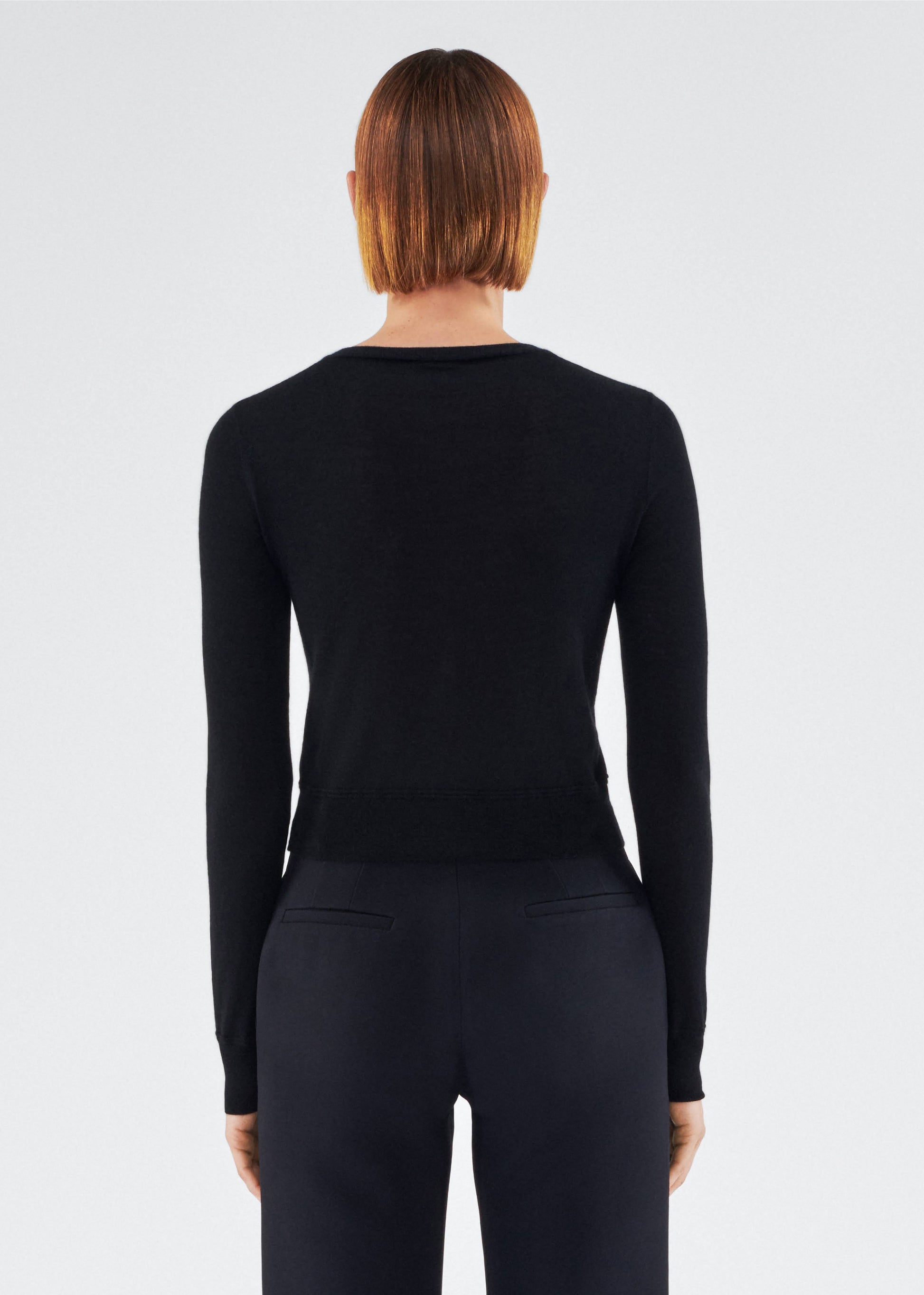 back view of model wearing the adam lippes cardigan in cashmere silk in black