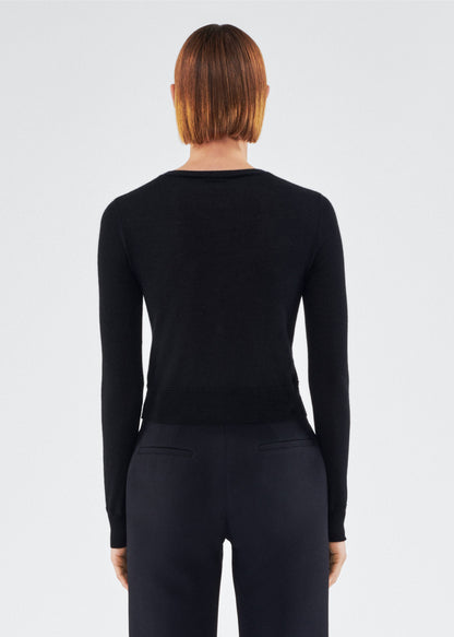back view of model wearing the adam lippes cardigan in cashmere silk in black