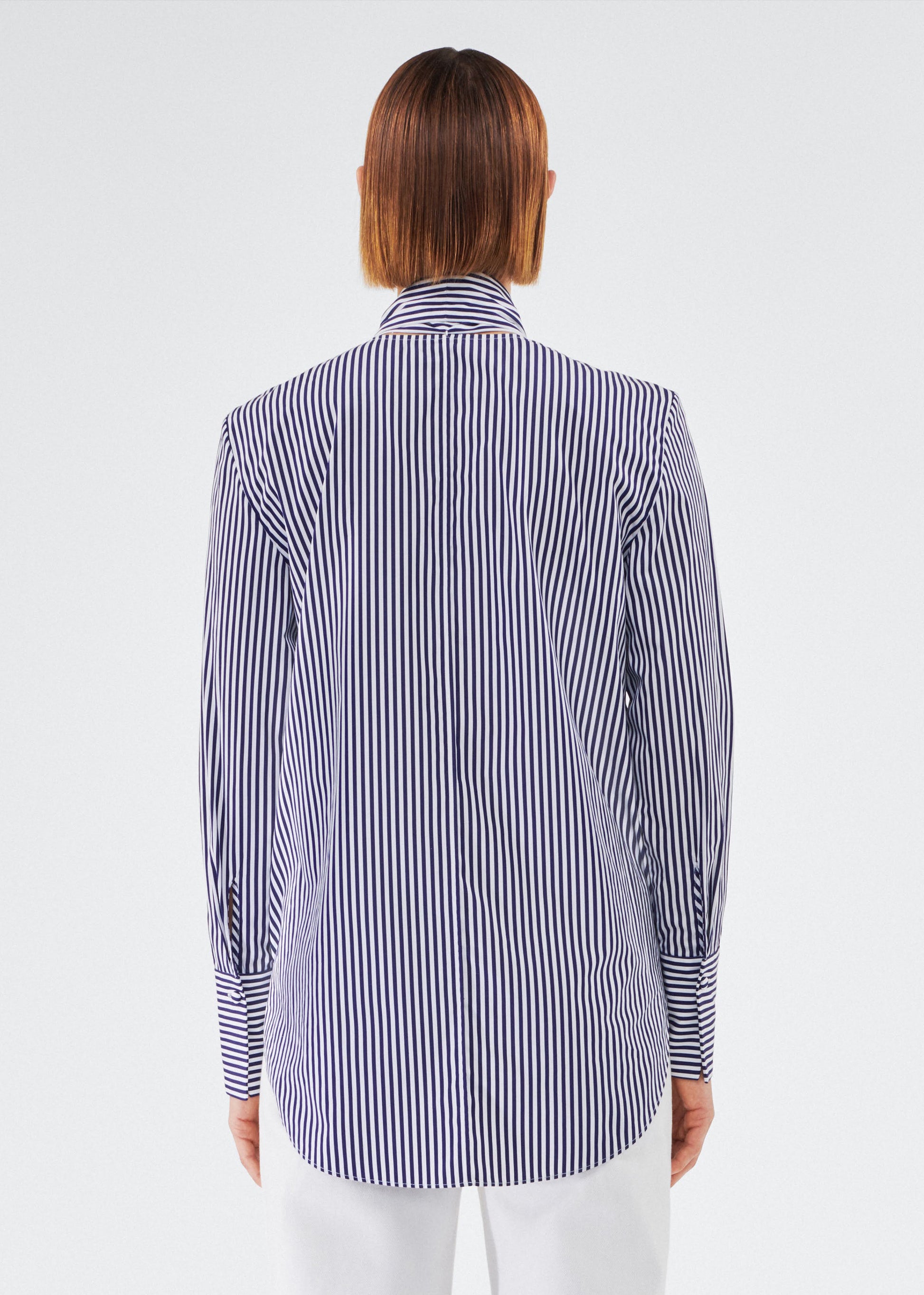 back view of model wearing lee blouse by adam lippes in striped poplin in navy and white