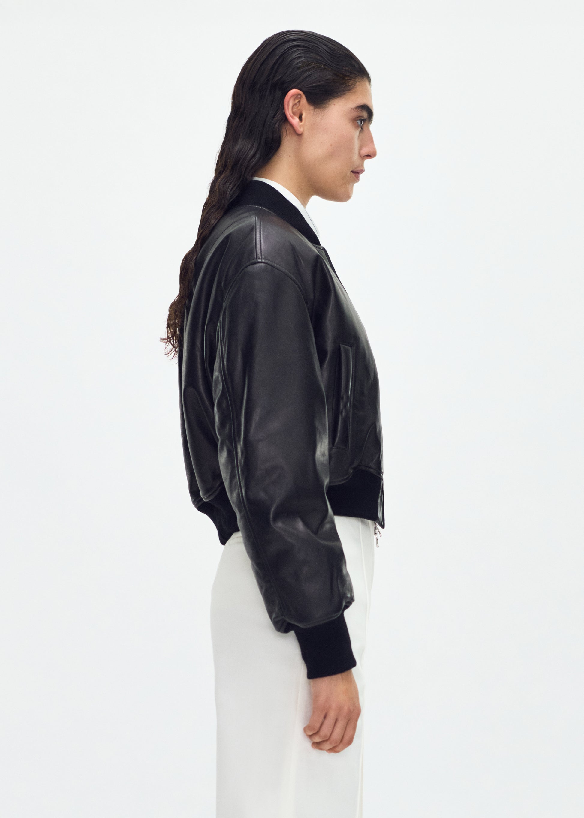 side profile of model wearing the Bomber Jacket in Black Leather